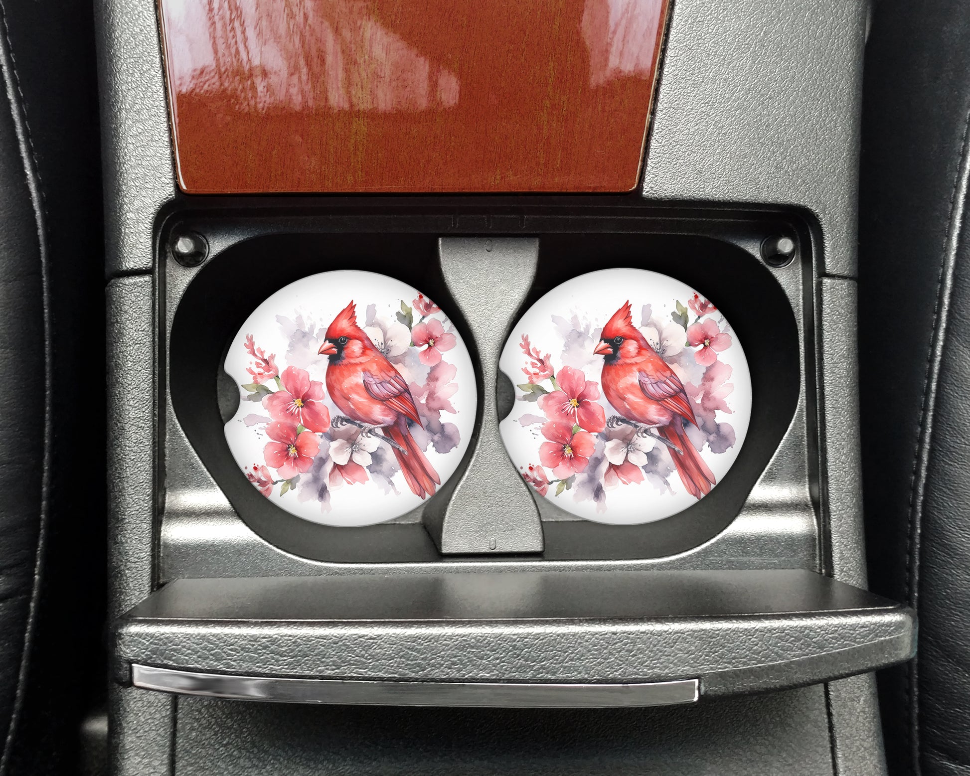 a pair of red birds sitting on top of a car seat